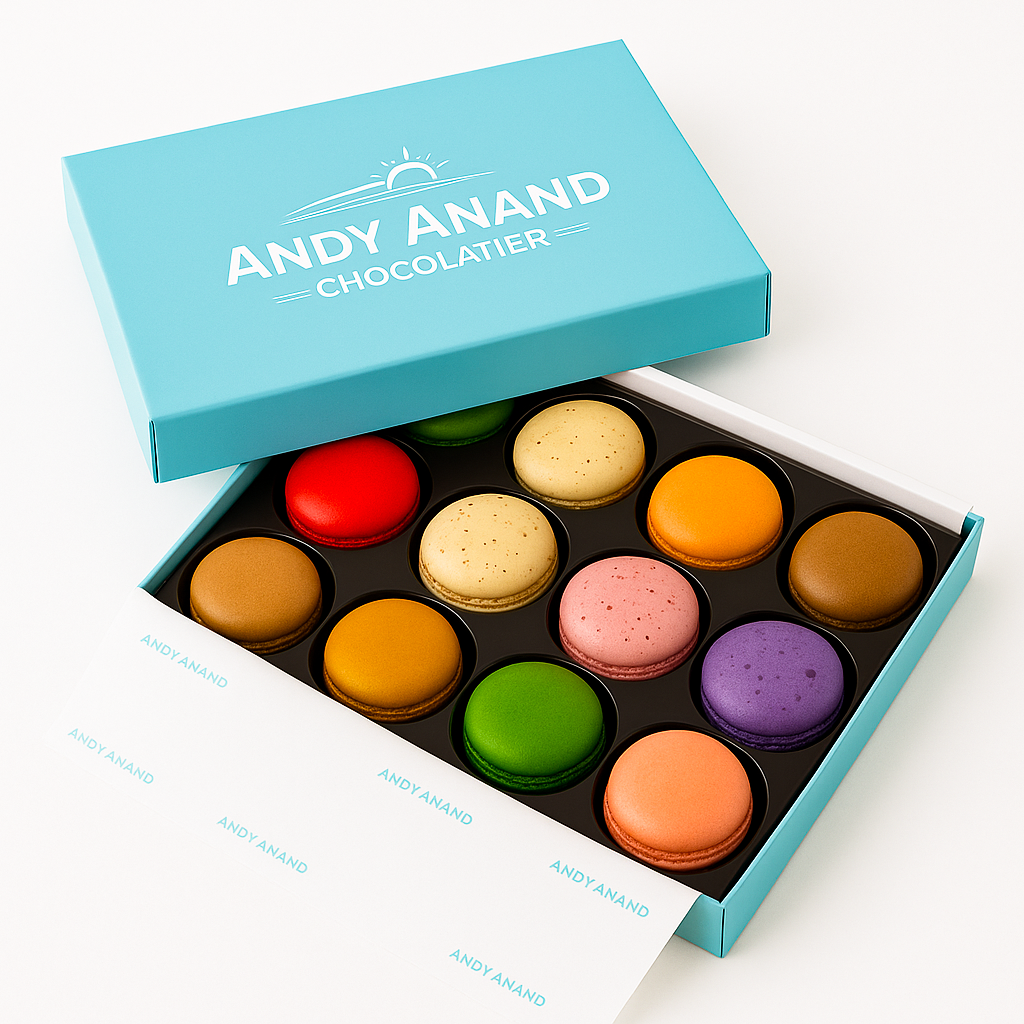 Box of 12 colorful French macarons in assorted flavors by Andy Anand, gift boxed and made fresh daily.
