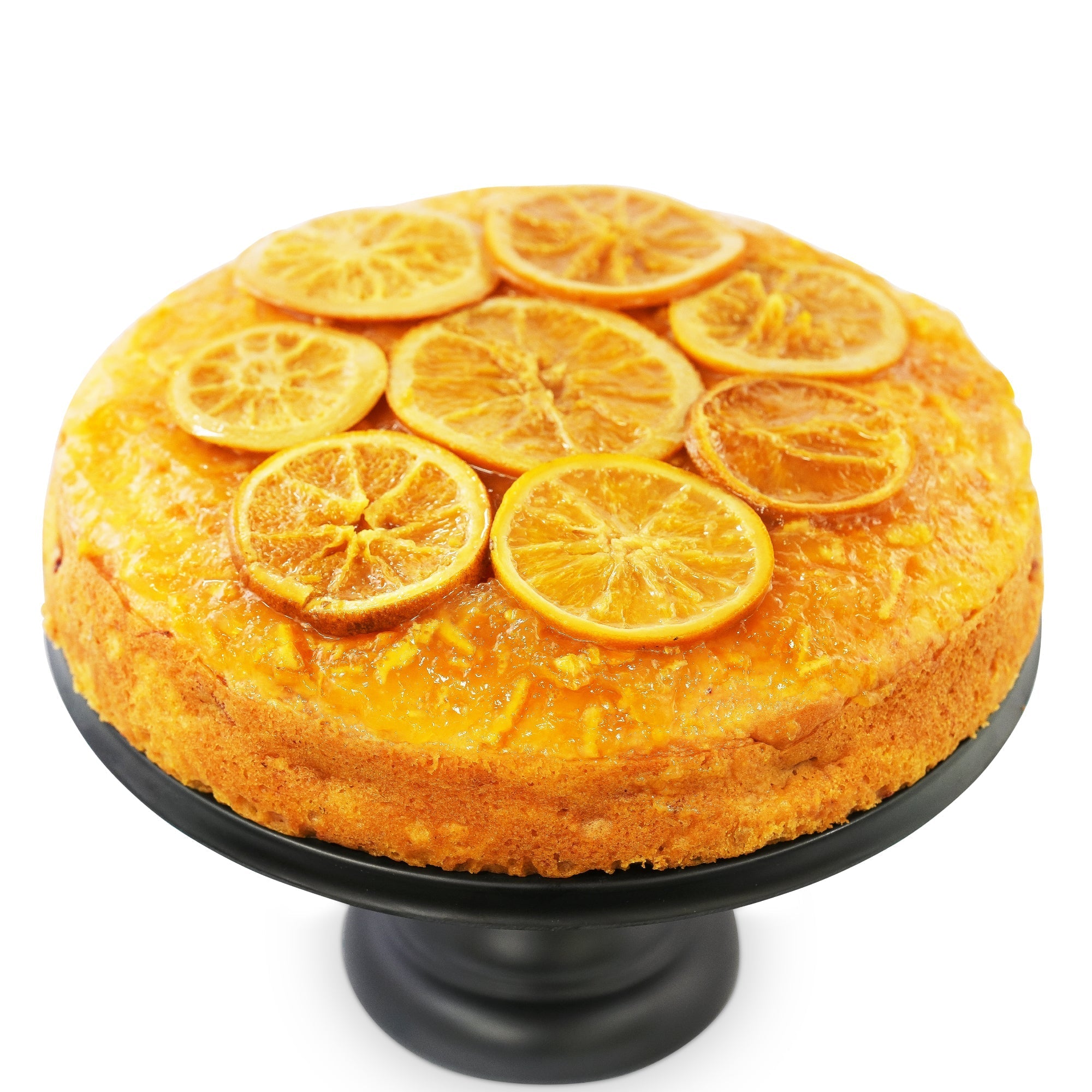 Gluten Free Orange Cake on a black stand, topped with slices of fresh orange, showcasing a rich, moist texture. Perfect for special occasions or daily indulgence. Andy Anand Chocolates, All Products, Products, Gluten Free Cheesecake & Cake
