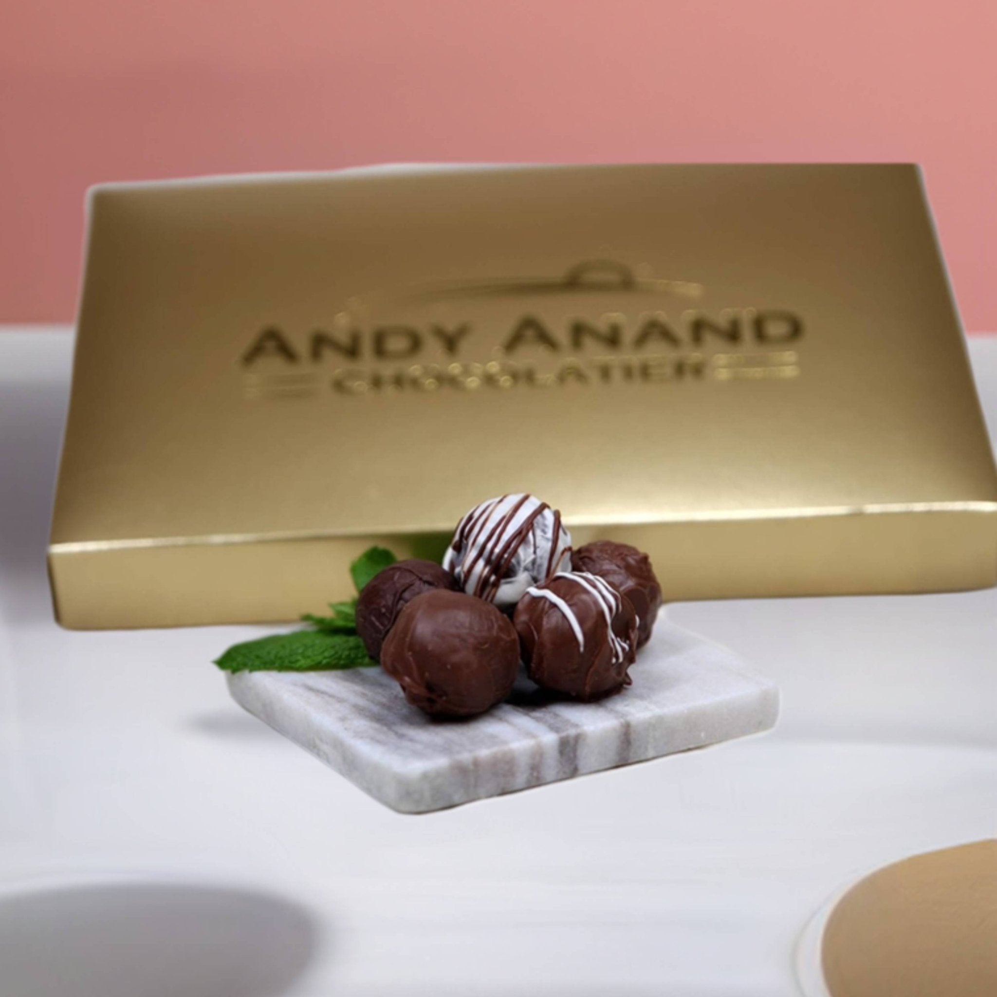 Belgian Chocolate Truffles Assorted with rum, Irish cream, and Kahlua, presented in a gift box by Andy Anand Chocolates, a premium brand offering all-natural, artisanal chocolate products.
