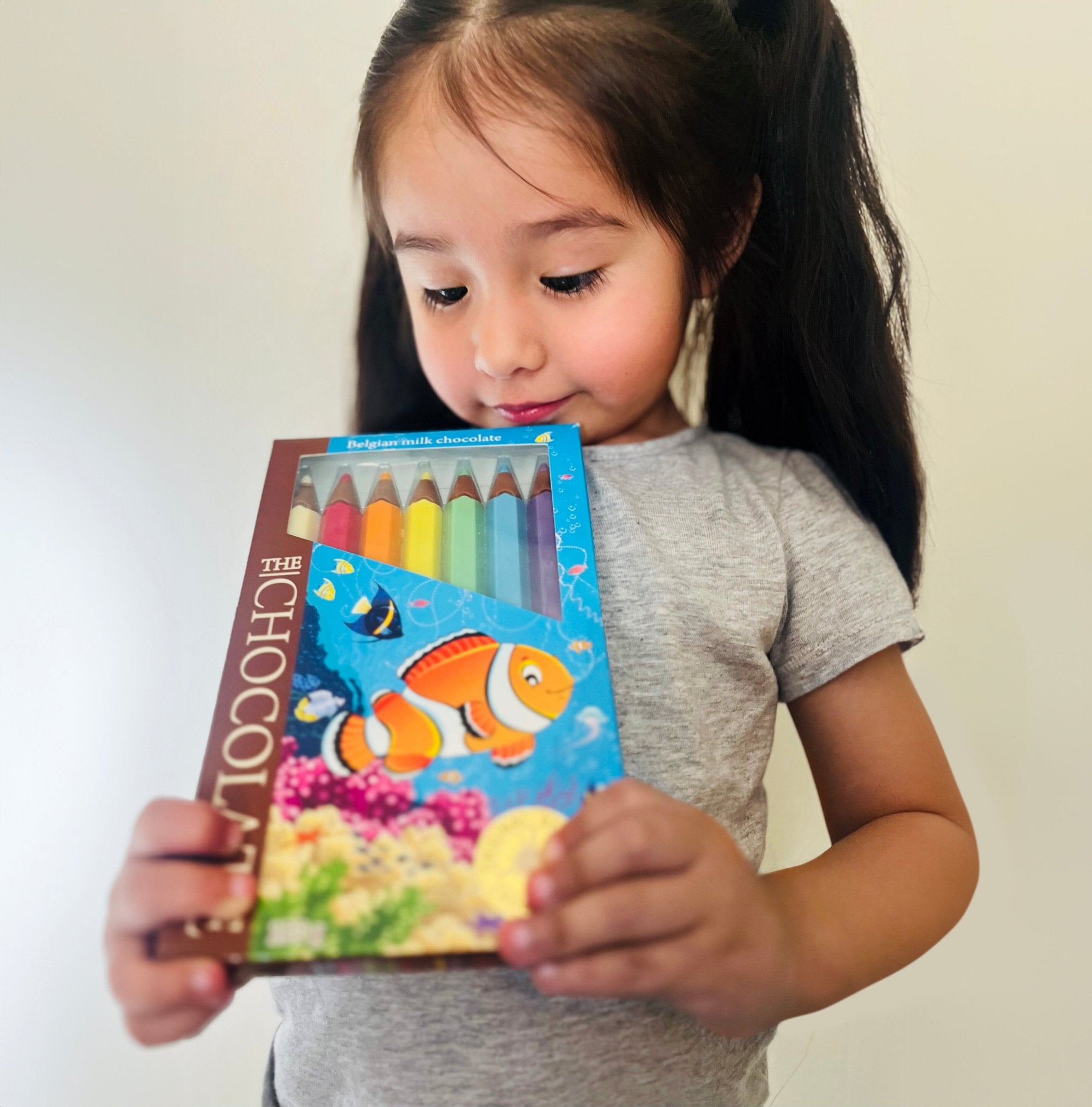 Milk Chocolate Colorful chocolate crayon boxes offer a delightful treat for kids, featuring a variety of milk chocolate pencils imported from Europe.