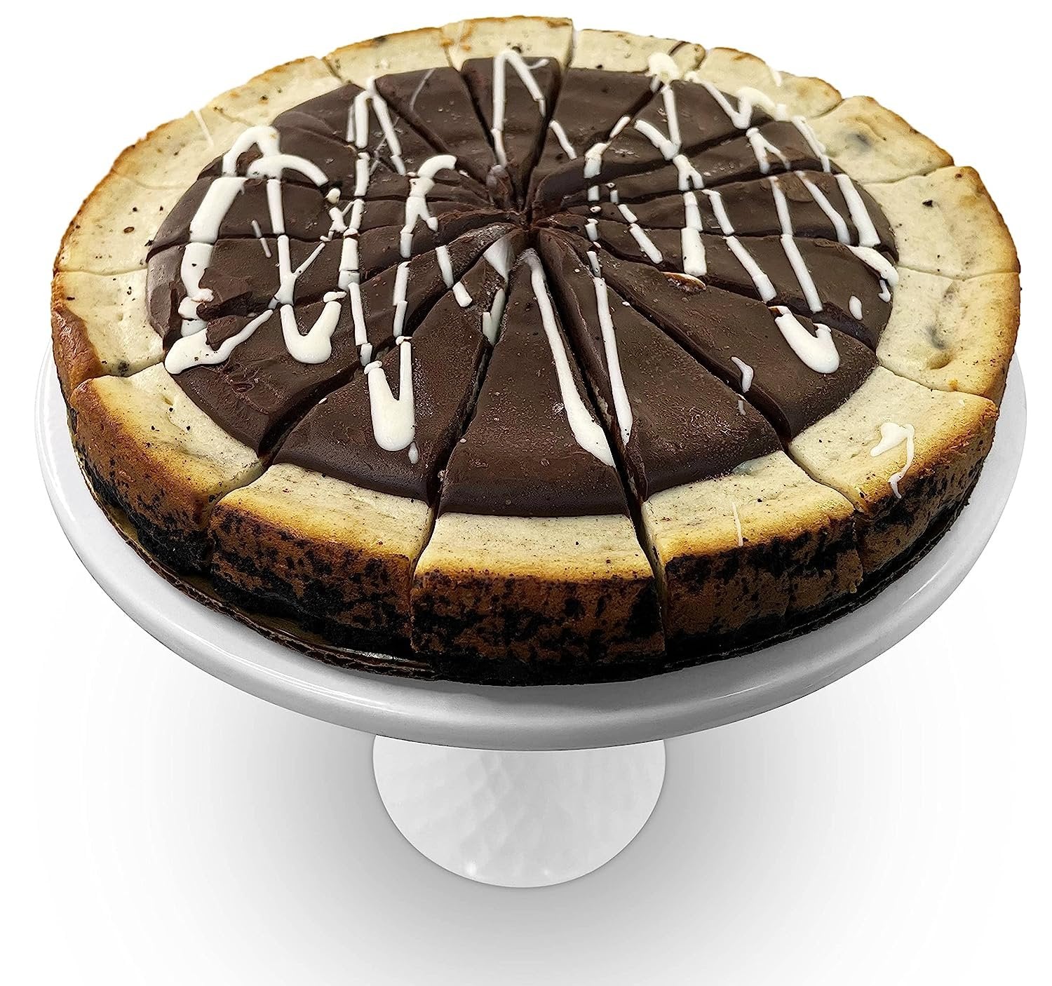 Cookies and Cream Cheesecake 9-inch freshly baked with chocolate swirls and white icing drizzle on a white cake stand