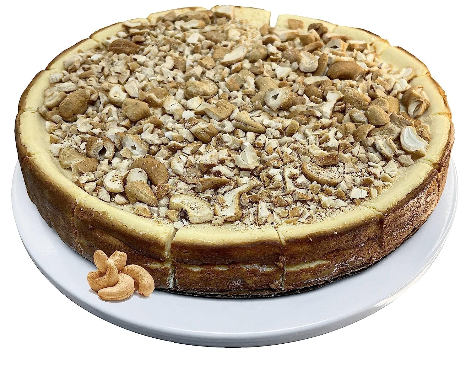 Delicious sugar-free gluten-free caramel cashew cheesecake by Andy Anand, 9-inch, plated for elegant presentation.