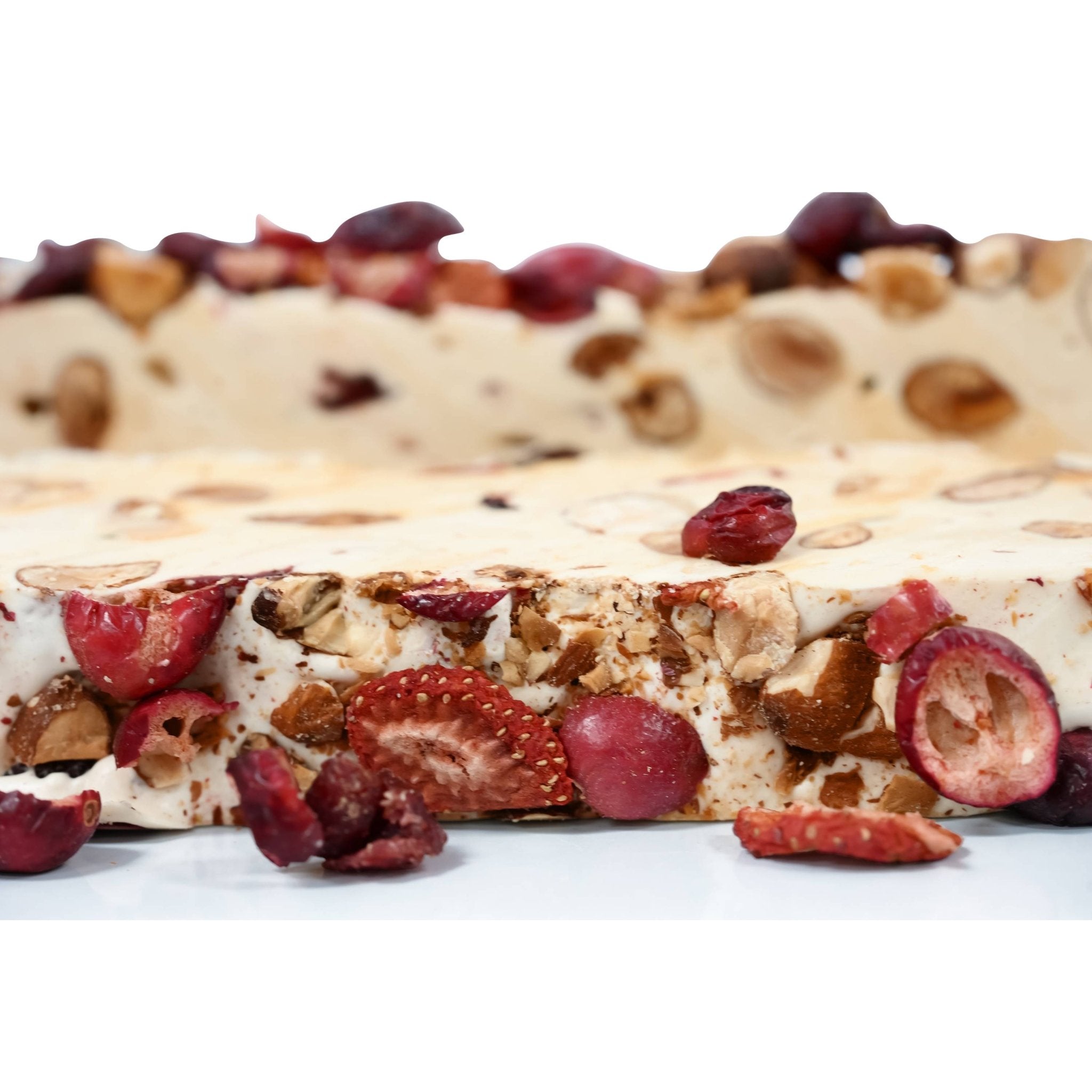 Red Fruit Almond Nougat red fruits (cherries, strawberries, raspberries), nougat, and turron with wildflower honey - a delectable confection from Andy Anand Chocolates, all products.