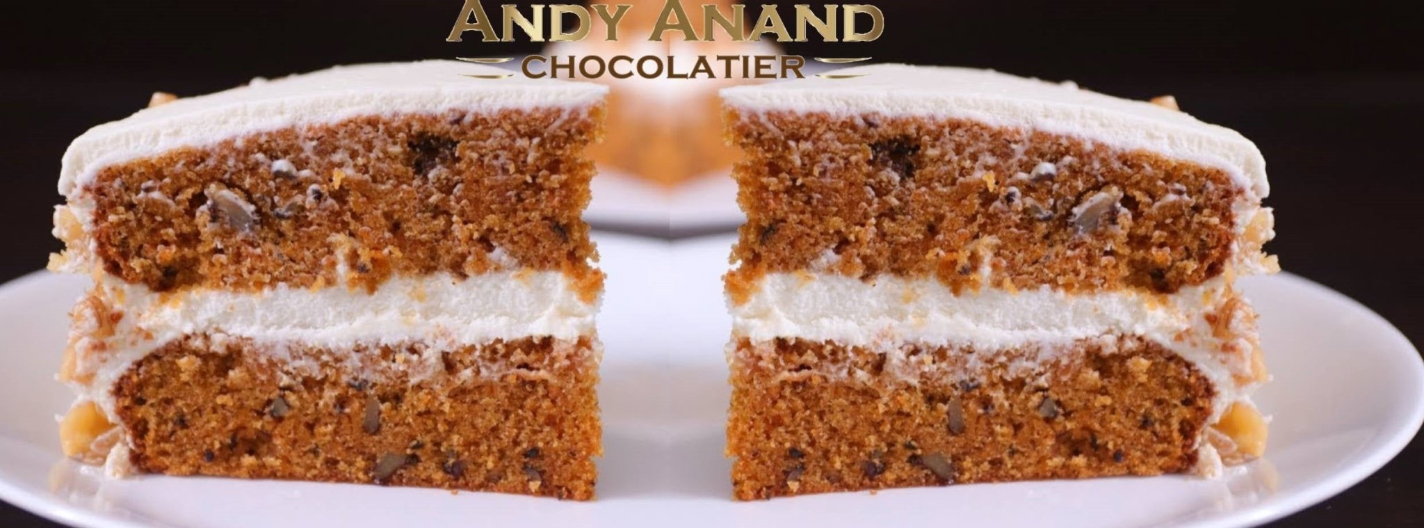 Two slices of Andy Anand sugar free carrot cake with creamy white frosting on a white plate
