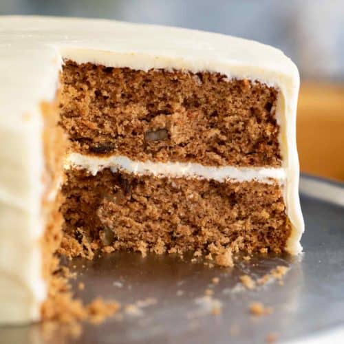 Freshly baked sugar free carrot cake with creamy white frosting and moist layered texture