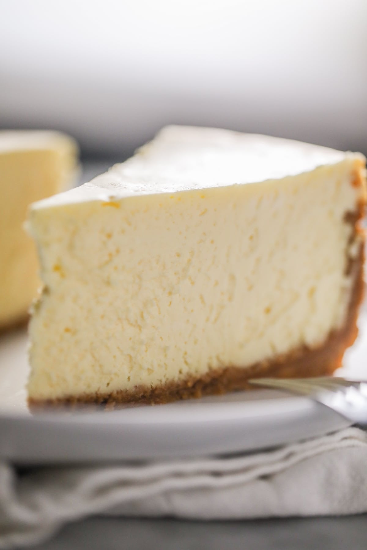 Slice of creamy sugar-free New York cheesecake with graham cracker crust, diabetic-friendly and freshly baked, ideal cheese cake near me for celebrations and dessert lovers.