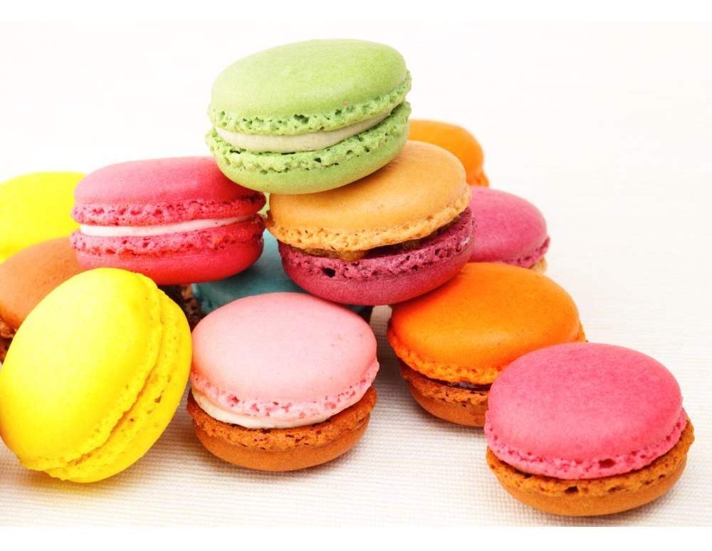 Andy Anand French macarons assortment in vibrant colors and flavors, beautifully stacked.