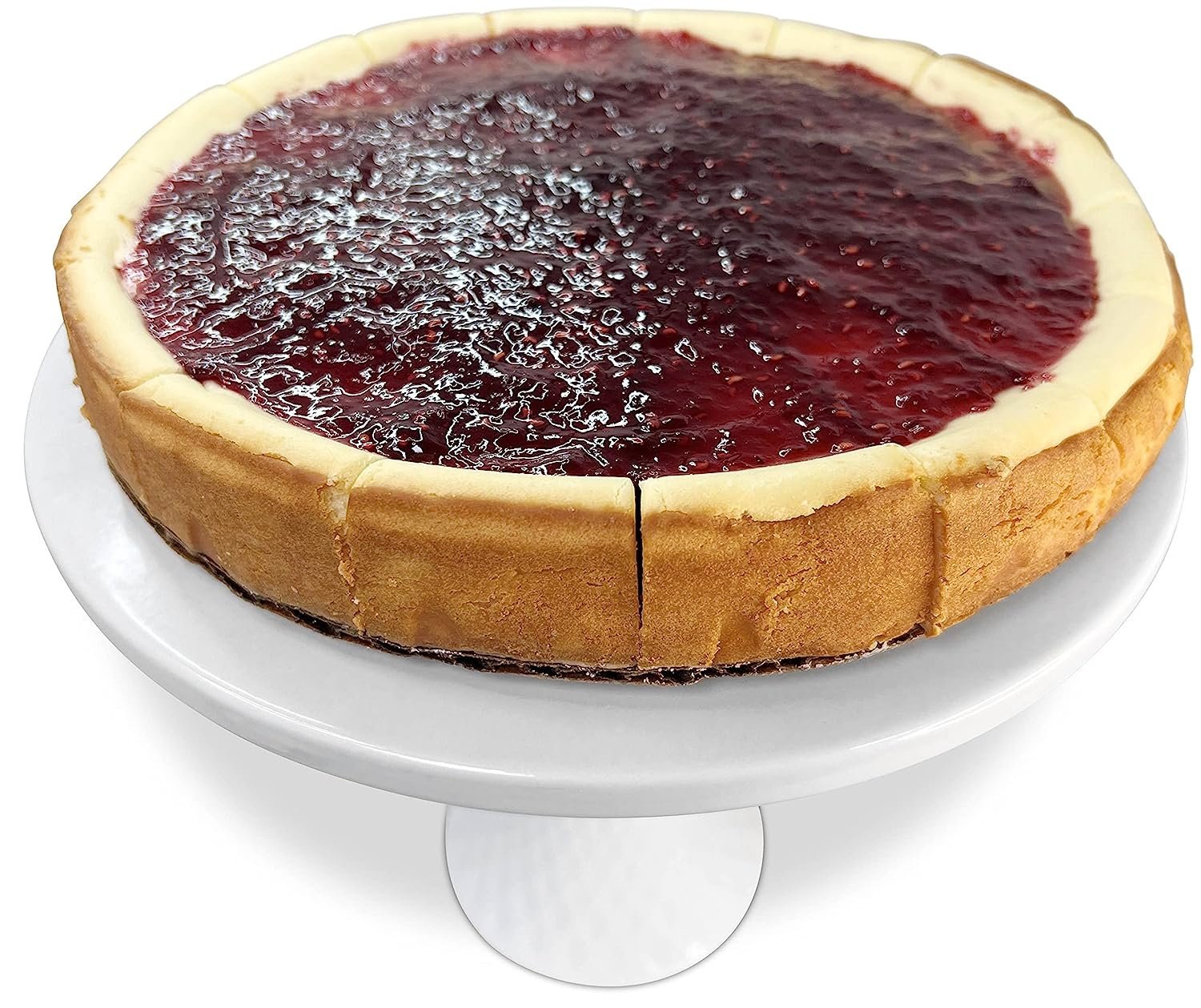 Andy Anand freshly baked 9-inch raspberry cheesecake with creamy crust on white cake stand