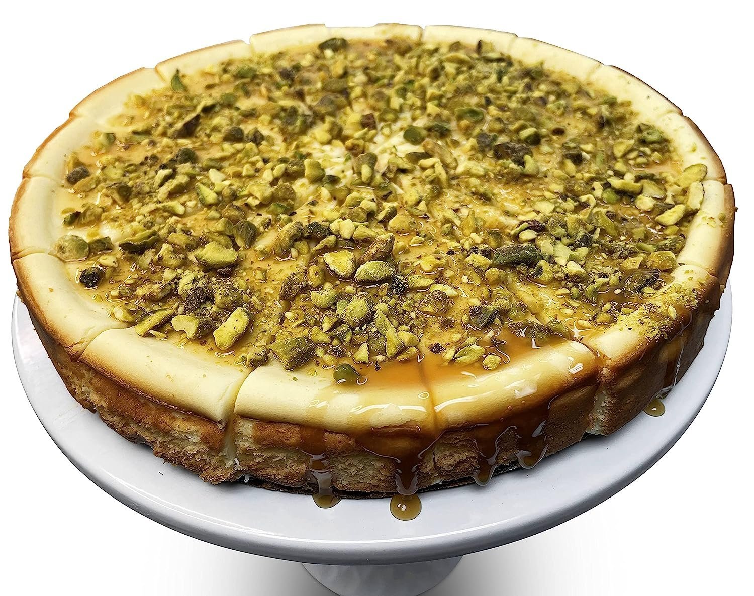 Gluten Free Caramel Pistachios Cheesecake Mouthwatering image of a delectable gluten-free caramel pistachios cheesecake, beautifully crafted using traditional methods, and showcasing a rich, creamy texture with a topping of crunchy pistachios. Andy Anand Chocolates, All Products, Products, Gluten Free Cheesecake & Cake.