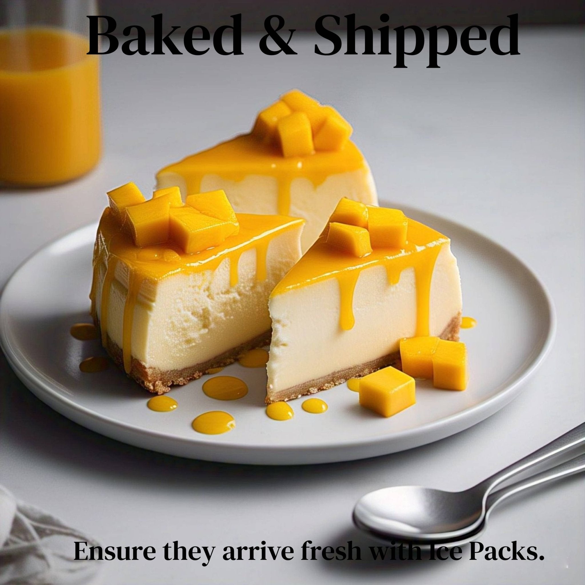 Mango Cheesecake Three slices of Andy Anand Traditional Mango Cheesecake topped with fresh mango cubes and mango sauce on a white plate with a spoon and a glass of mango juice in the background