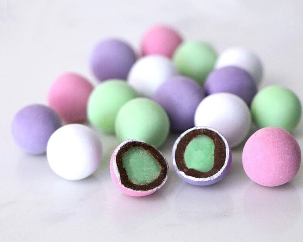 Belgian Dark Chocolate Mint Assortment of colorful chocolate-covered malt balls, including pink, purple, green, and white varieties. Andy Anand Chocolates, All Products, Products, Malt Balls