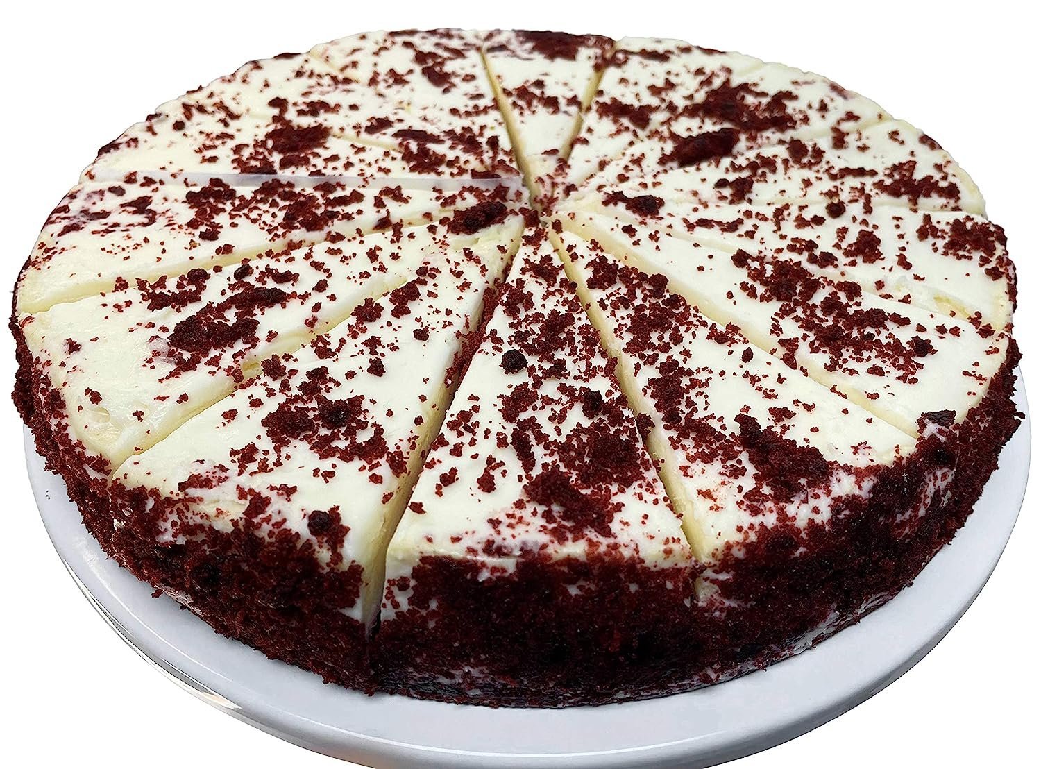 Freshly baked 9-inch red velvet cheesecake with creamy white frosting and red velvet cake crumbs, sliced and served on a white plate