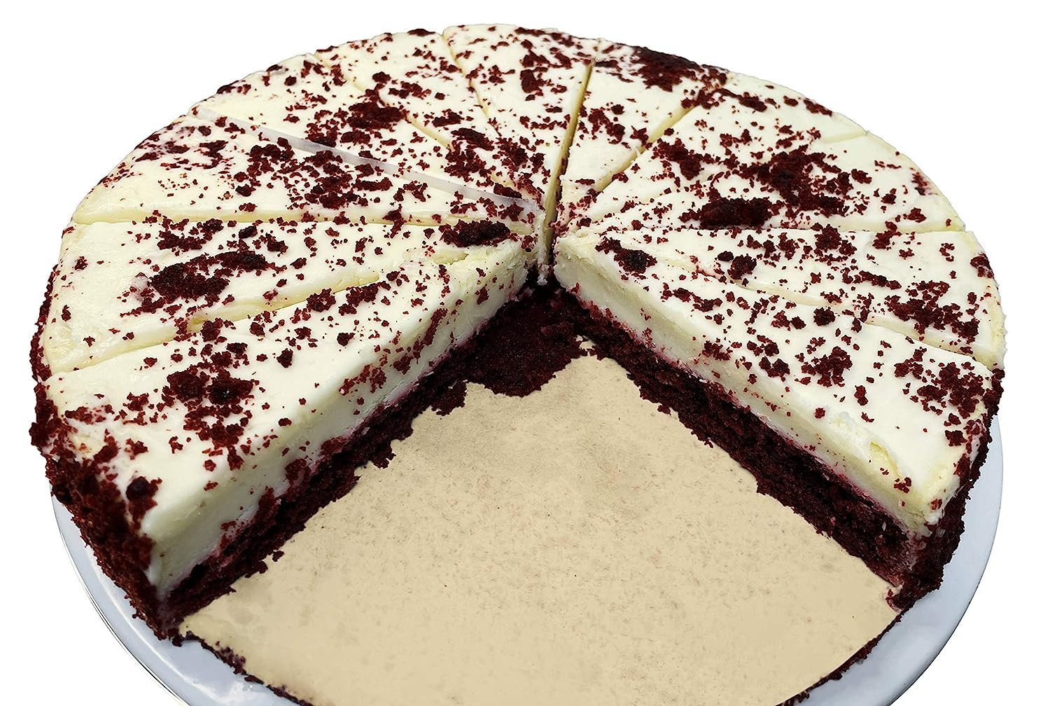 Freshly baked Red Velvet Cheesecake 9-inch with creamy white frosting and red velvet crumbs, sliced and served on a white plate