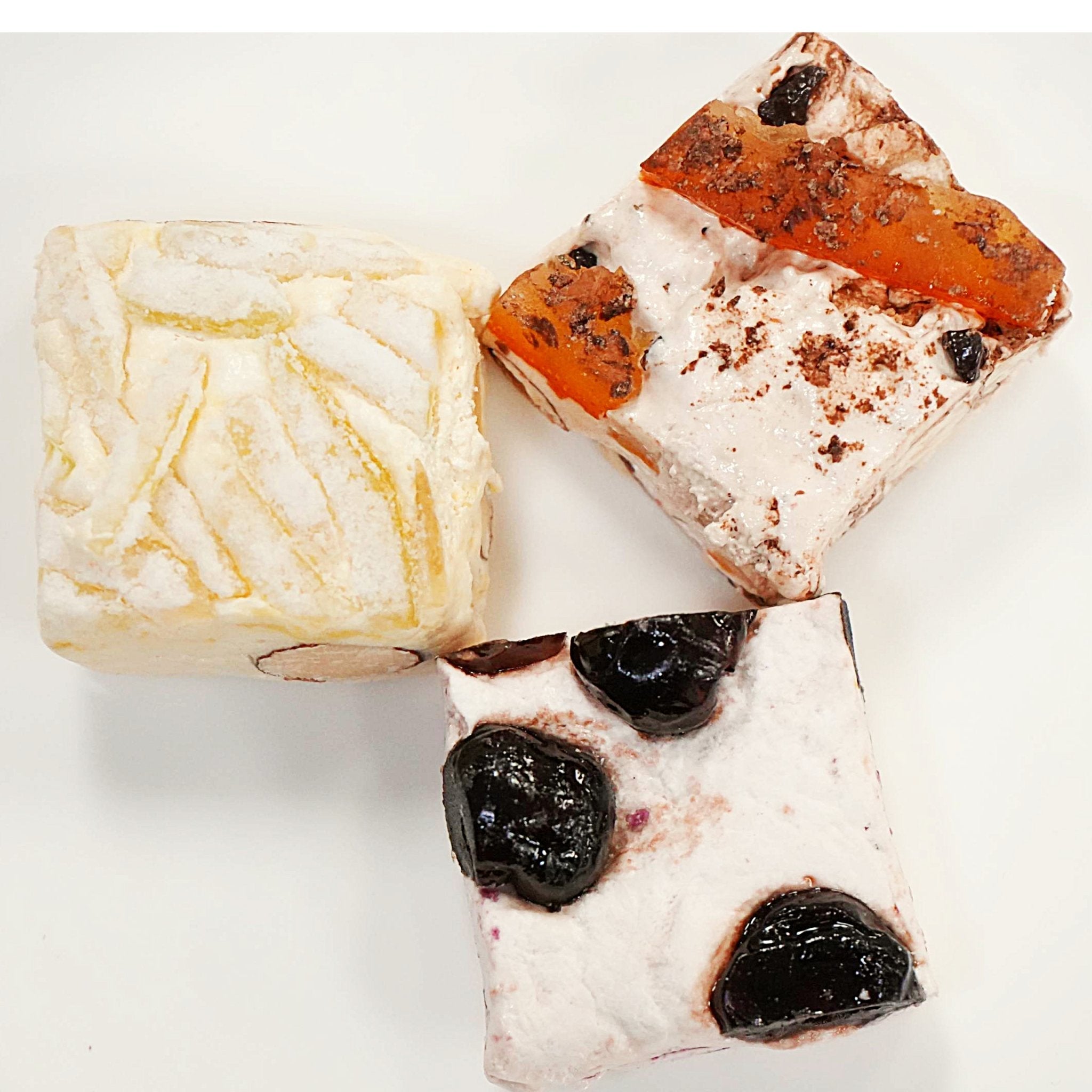 Almond Nougat Turron Candy Assortment of Andy Anand Chocolates, Bite-sized soft nougat brittle with cherry, chocolate orange, and lemon flavors. Andy Anand Chocolates, All Products, Products, Soft Brittle Nougat, -Brittle, Brittle / Turron.