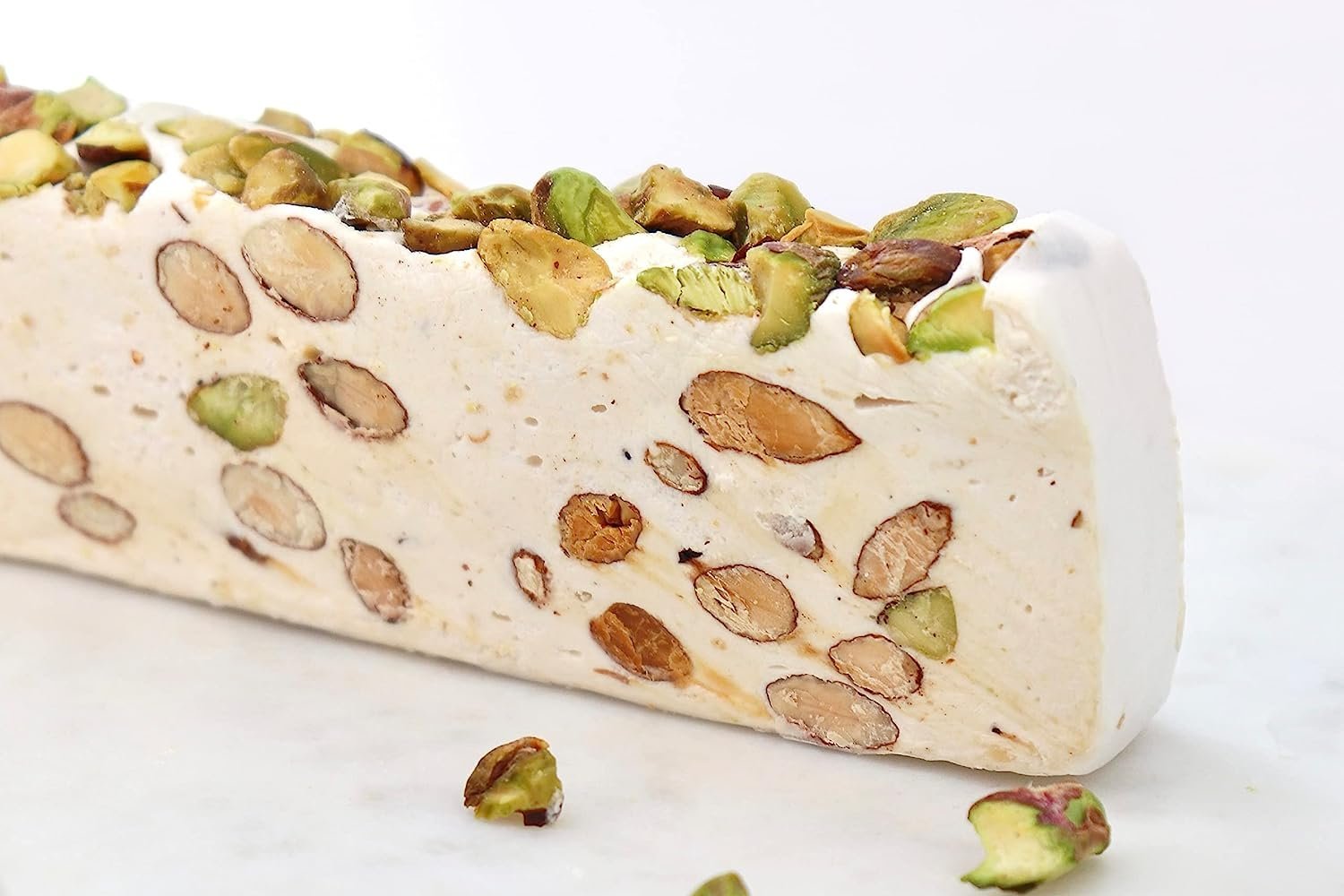 Pistachio Nougat Turron Delectable roasted pistachios encased in a soft, brittle nougat confection, crafted with care by Andy Anand Chocolates. This decadent treat showcases the finest ingredients and artisanal techniques, transporting you to the sun-drenched landscapes of Spain. Andy Anand Chocolates, All Products, Products, Soft Brittle Nougat, -Brittle, Brittle / Turron.