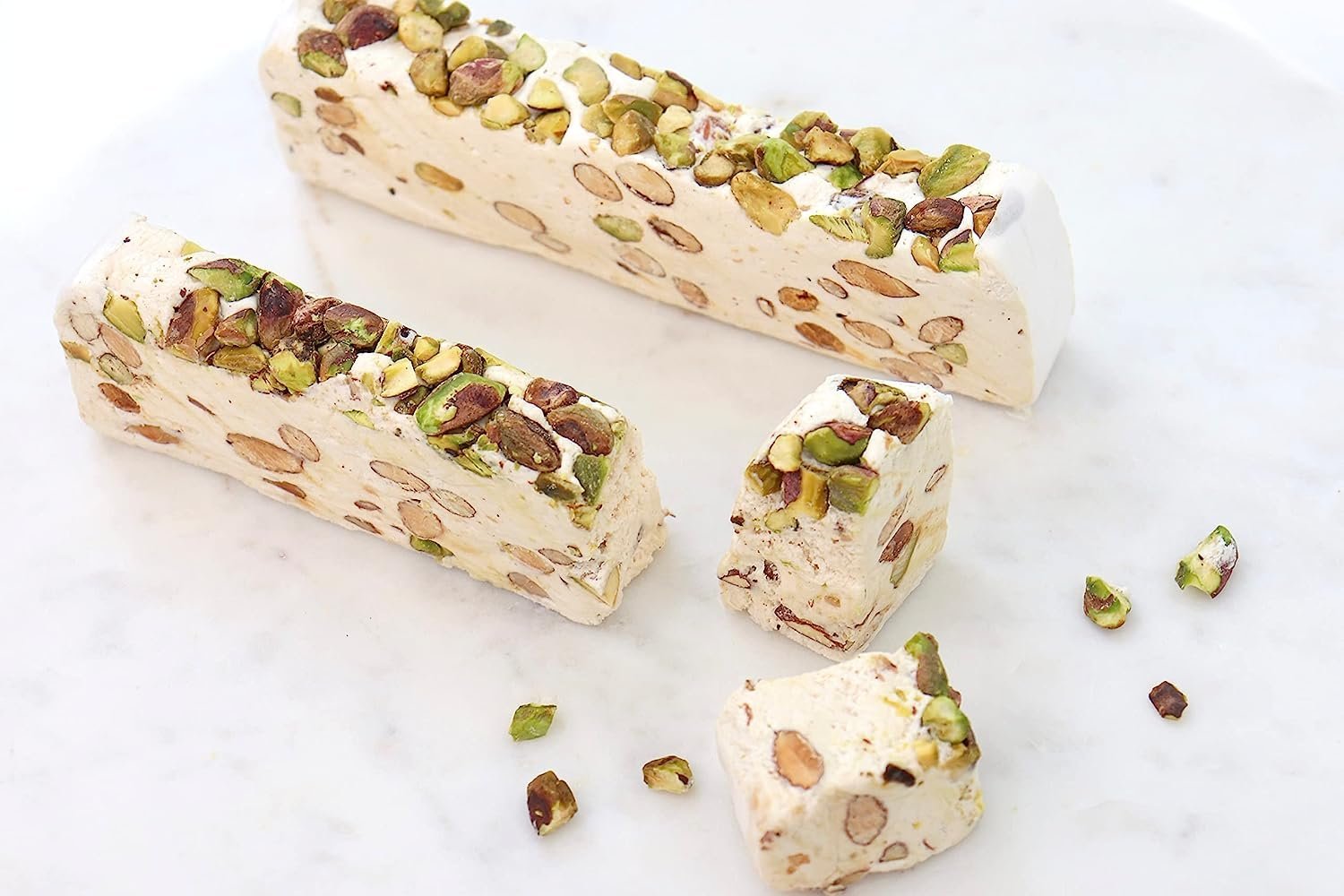 Pistachio Nougat Turron Delectable roasted pistachios embedded in a soft, brittle nougat confection - a decadent Spanish delight from Andy Anand Chocolates. All Products, Products, Soft Brittle Nougat, -Brittle, Brittle / Turron