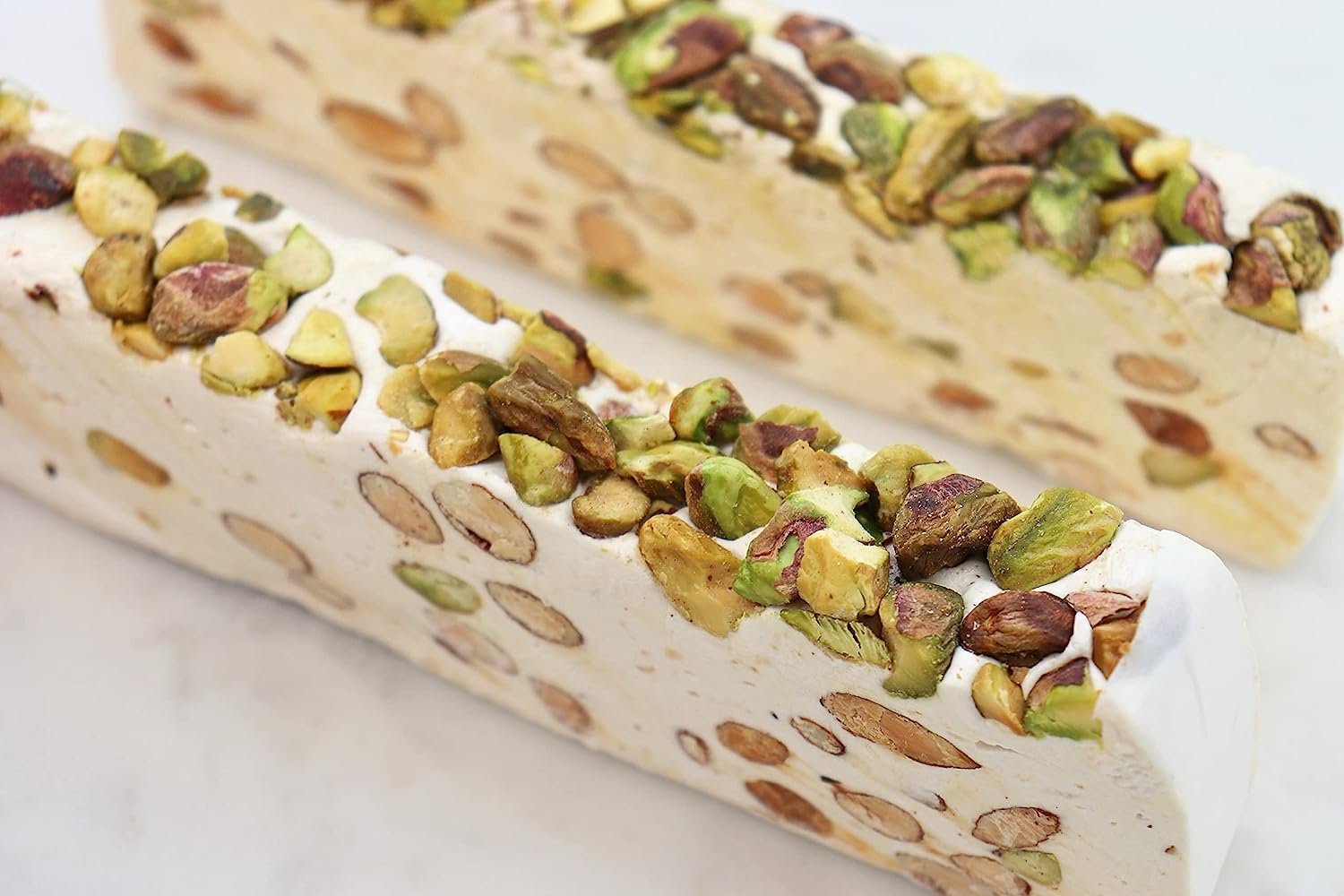 Pistachio Nougat Turron Delectable Spanish turron with roasted pistachios, nougat, and brittle. Handcrafted confection from the renowned Casa De Jijona estate. Andy Anand Chocolates, All Products, Products, Soft Brittle Nougat, -Brittle, Brittle / Turron