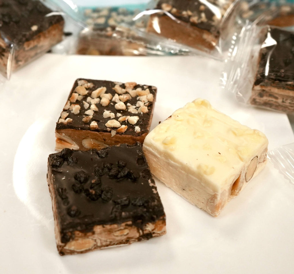 Indulge in Andy Anand's Luxurious Roasted Almond Soft Nougat White Chocolate & Dark Chocolate Treats in Southern California