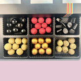 Assorted licorice and chocolate confections in a gift box, Andy Anand Chocolates, All Products, Products.