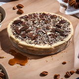 A beautifully presented Sugar-Free Caramel Pecan Cheesecake by Andy Anand, featuring a rich and creamy texture topped with a generous layer of pecans and caramel sauce. This 2.8 lbs cheesecake is a perfect blend of taste and quality, ideal for guilt-free indulgence. Andy Anand Chocolates, All Products, Products, Cheesecake Sugar Free.