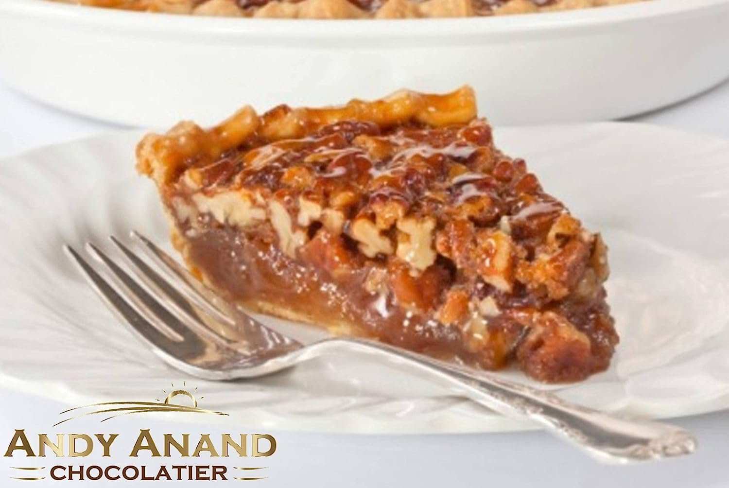 Traditional Pecan Pie Cake featuring a rich, creamy filling with crunchy pecans and a flaky crust, made with real butter and Georgia pecans. Artfully crafted and thoughtfully packaged as a delightful treat. Andy Anand Chocolates, All Products, Products, Pies.